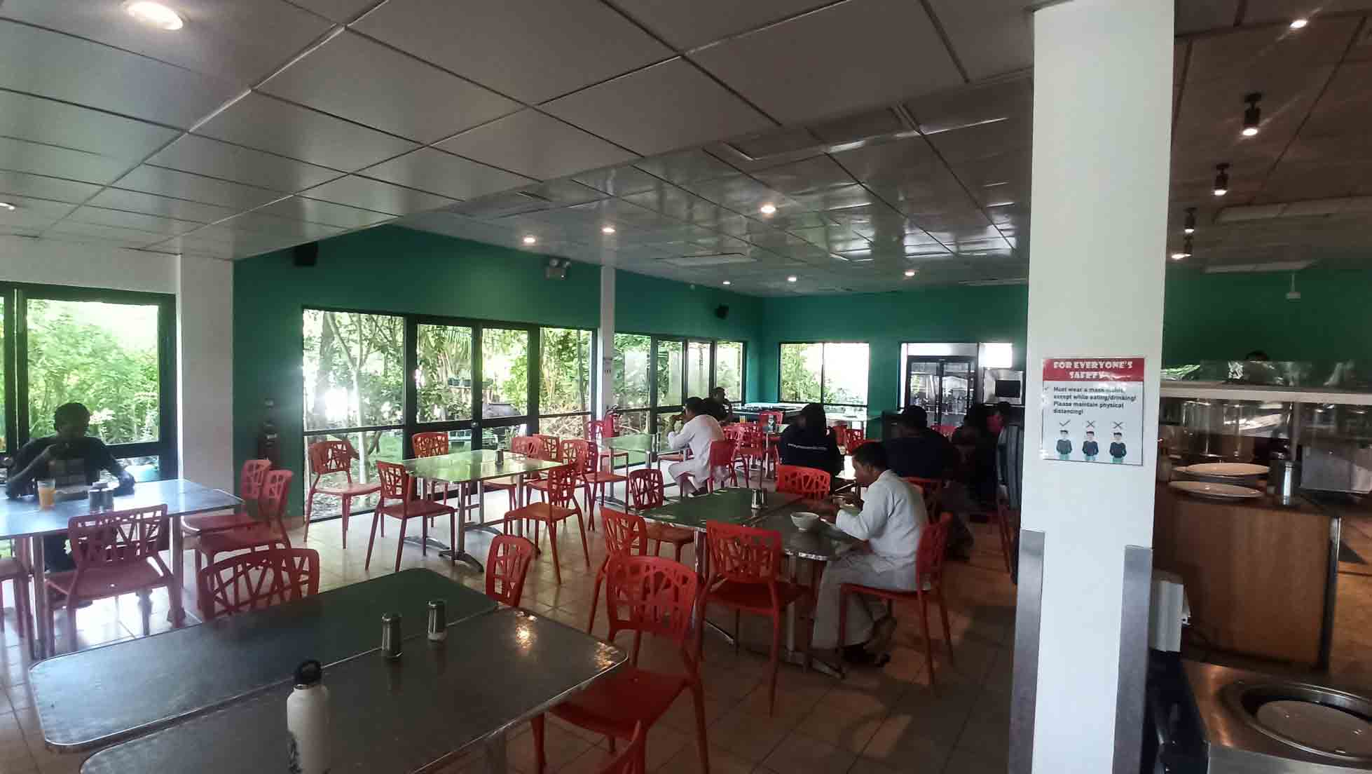 people sitting on a chair in a cafeteria on a private island in Maldives